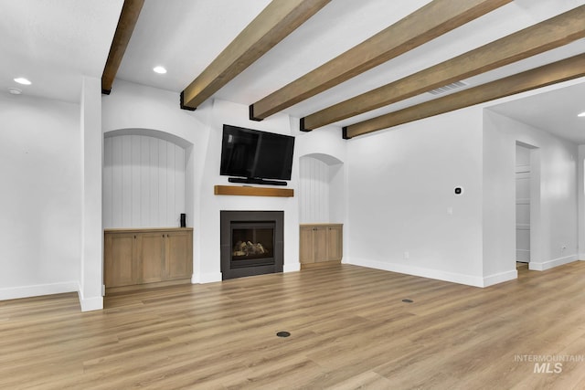 2499 E Berghan Ln, Meridian, ID 83642 - unfurnished living room featuring baseboards, beam ceiling, light wood-style floors, a large fireplace, and recessed lighting