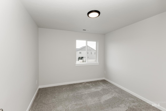 carpeted empty room with baseboards and visible vents