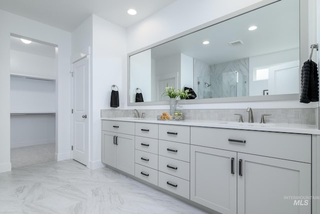 bathroom with a shower and vanity