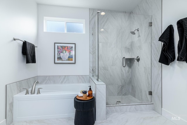 bathroom featuring separate shower and tub