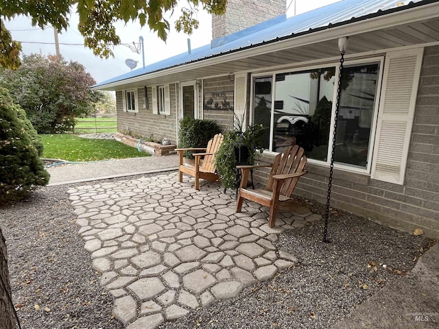 view of patio / terrace featuring fence
