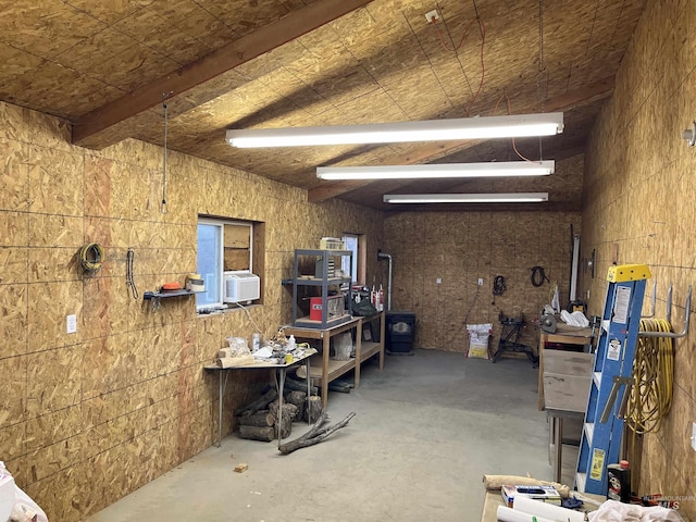 miscellaneous room featuring cooling unit and unfinished concrete floors