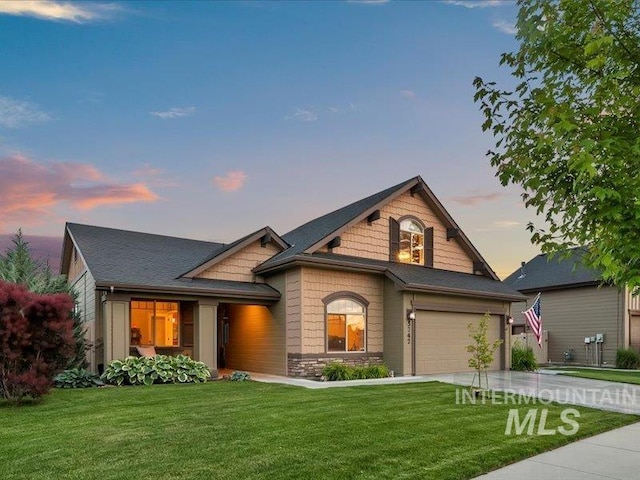5747 W Rotherham Dr, Eagle, ID 83616 - view of front of home with driveway, a garage, a front lawn, and stone siding