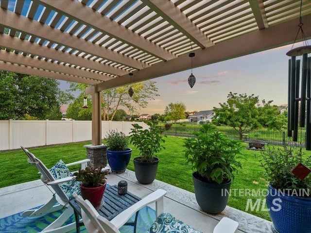 5747 W Rotherham Dr, Eagle, ID 83616 - patio terrace at dusk with a fenced backyard, a patio area, and a pergola