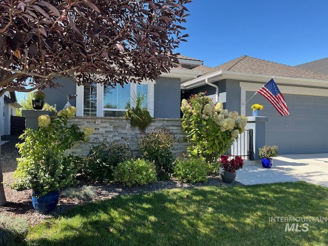 view of front of property with a front yard and a garage