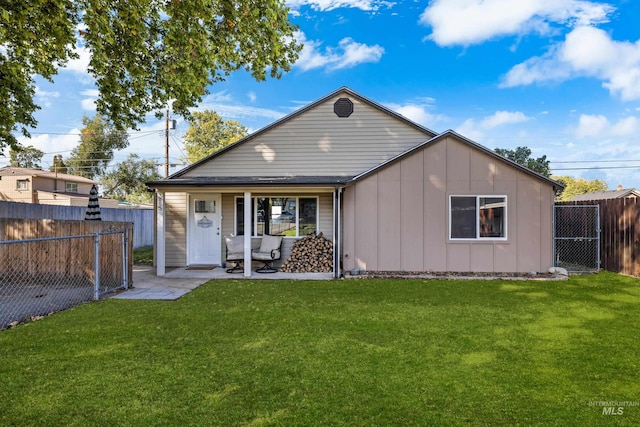 rear view of house with a yard