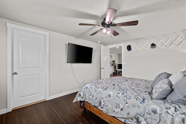 bedroom featuring a textured ceiling, ceiling fan, and dark hardwood / wood-style flooring