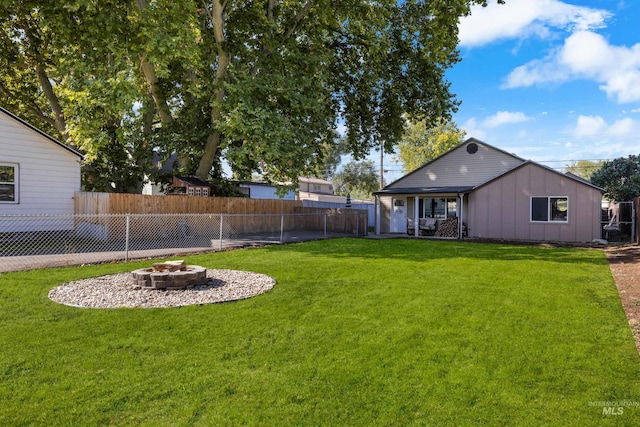 view of yard featuring a patio and an outdoor fire pit