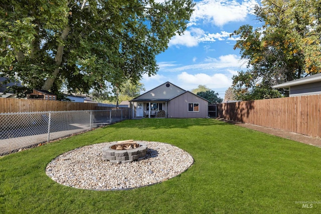 view of yard with a fire pit