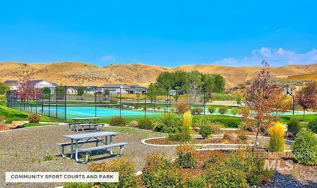 view of home's community featuring tennis court and a mountain view