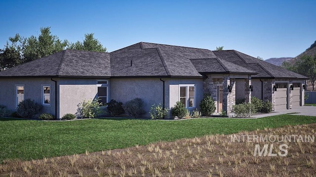 view of front of property featuring a garage and a front yard