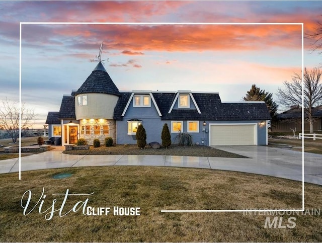 view of front of home with an attached garage, a yard, driveway, and stucco siding