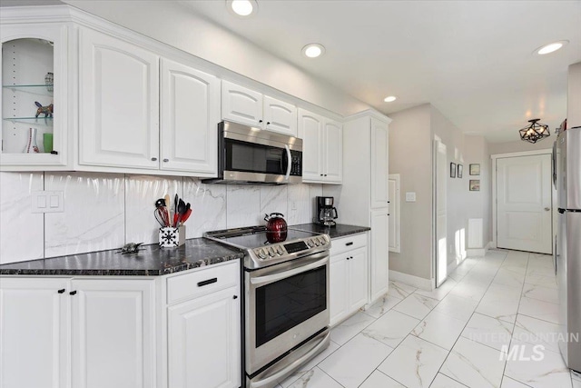 kitchen with recessed lighting, stainless steel appliances, white cabinets, marble finish floor, and backsplash