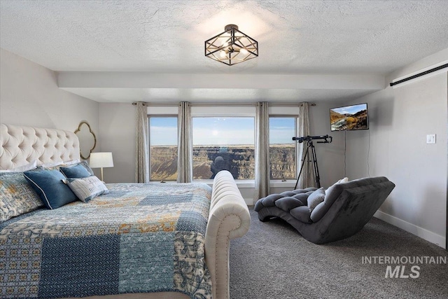 carpeted bedroom featuring a textured ceiling and baseboards