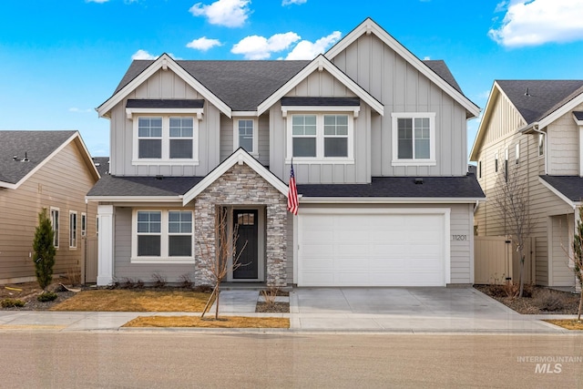 craftsman inspired home with driveway, stone siding, board and batten siding, roof with shingles, and an attached garage