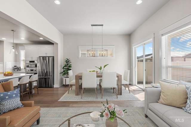 dining area with recessed lighting, a chandelier, and light wood finished floors