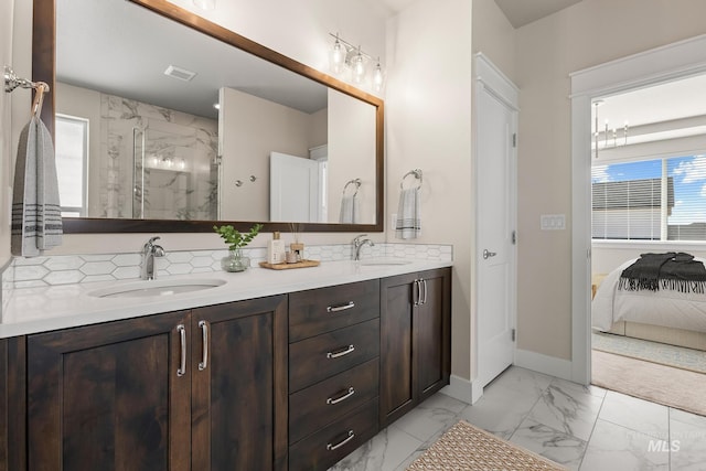 bathroom with a marble finish shower, visible vents, marble finish floor, and a sink