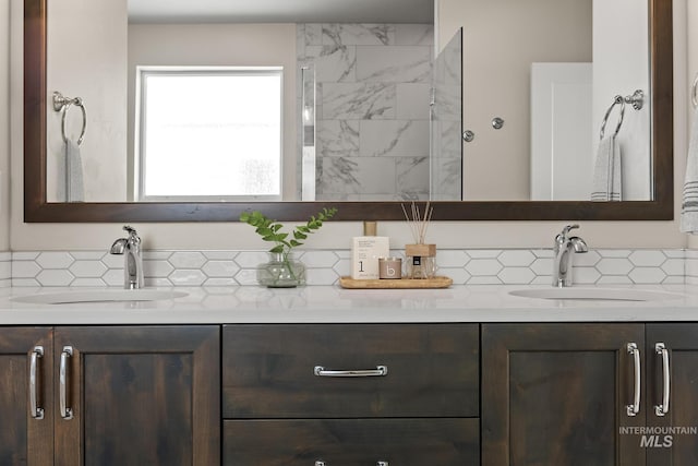 full bathroom with double vanity, tasteful backsplash, and a sink