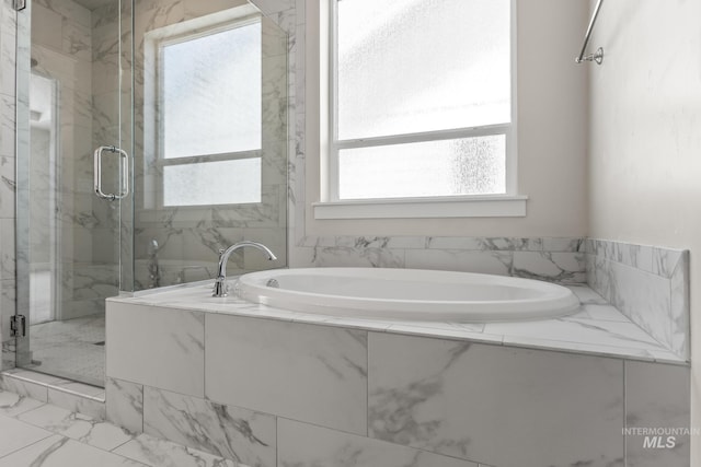 bathroom featuring a marble finish shower, marble finish floor, and a garden tub