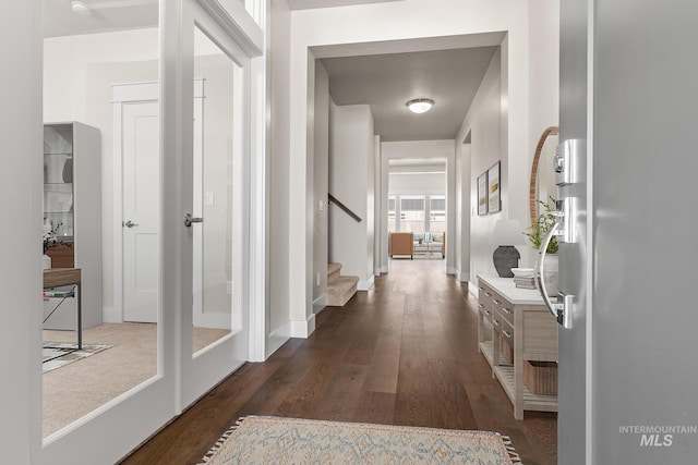 hall featuring stairway and dark wood-style flooring