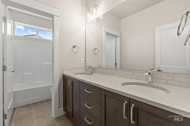 bathroom with tile patterned flooring, double vanity, and a sink