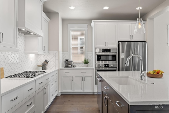 kitchen featuring a sink, white cabinets, dark wood-style floors, and stainless steel appliances