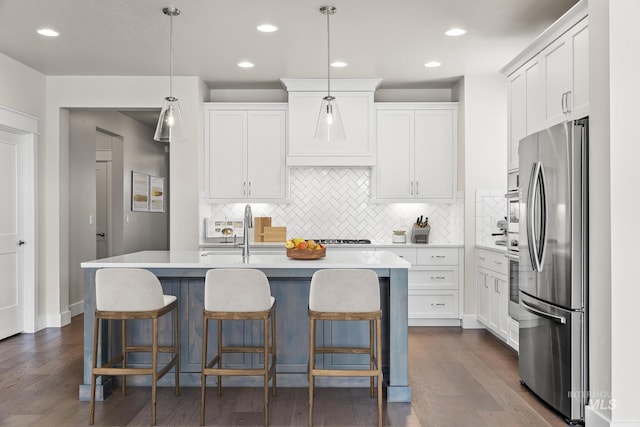 kitchen featuring a sink, white cabinets, light countertops, and freestanding refrigerator