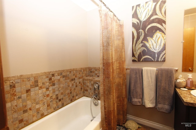 bathroom with a garden tub and vanity