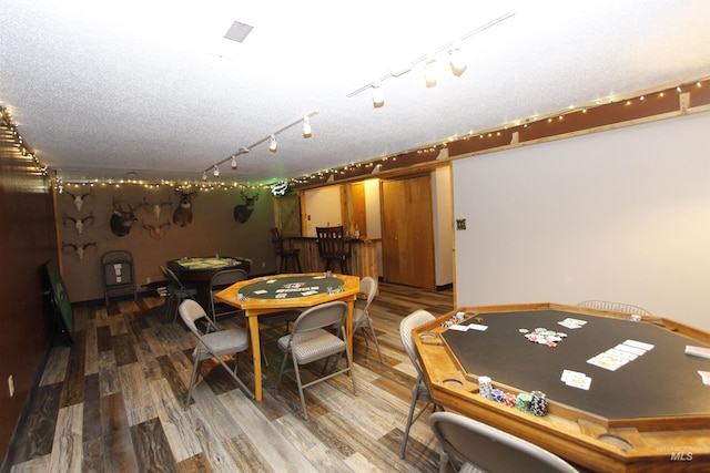 playroom featuring hardwood / wood-style floors and a textured ceiling