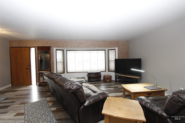 living room featuring baseboards and dark wood finished floors