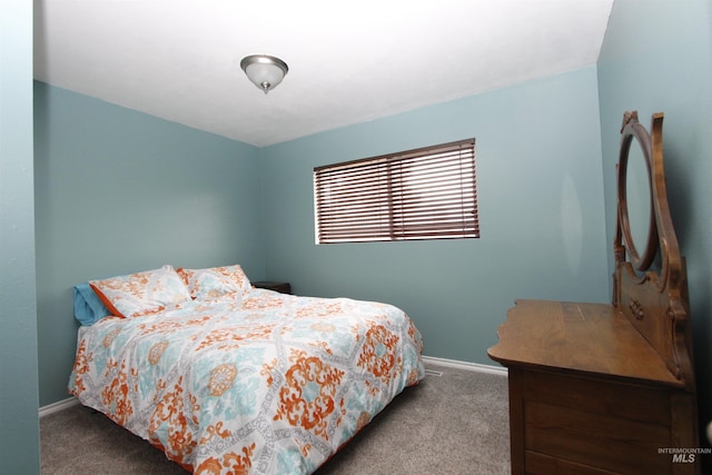 bedroom featuring light colored carpet and baseboards