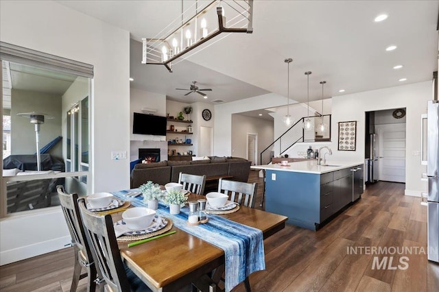 dining room with ceiling fan, dark hardwood / wood-style flooring, and sink