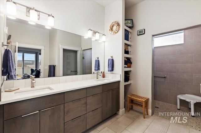 bathroom with vanity, tile patterned floors, and tiled shower