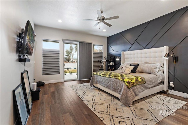 bedroom featuring access to outside, dark hardwood / wood-style floors, and ceiling fan