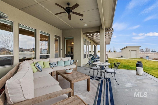 view of patio / terrace featuring ceiling fan, a storage unit, a pergola, and an outdoor living space