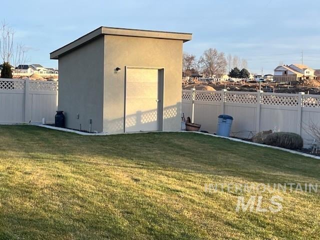 view of outbuilding with a yard