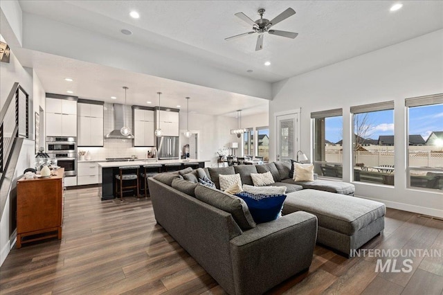 living room with dark hardwood / wood-style floors and ceiling fan