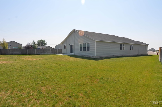 rear view of property with a lawn