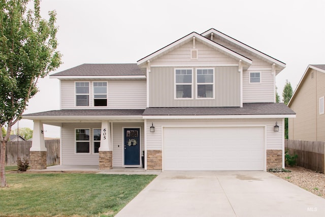 craftsman-style home with stone siding, concrete driveway, an attached garage, a porch, and board and batten siding