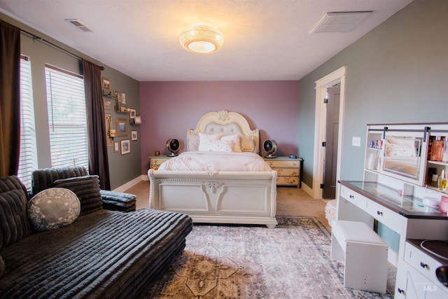 bedroom featuring baseboards and light colored carpet