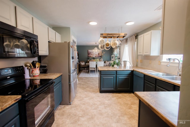 kitchen featuring black electric range oven, a sink, dishwashing machine, and white cabinets