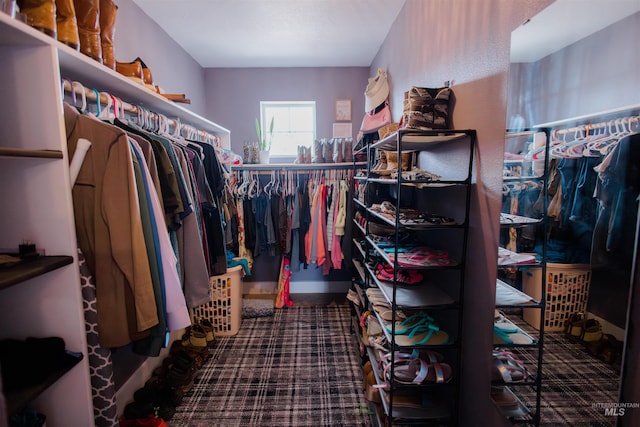 walk in closet with carpet