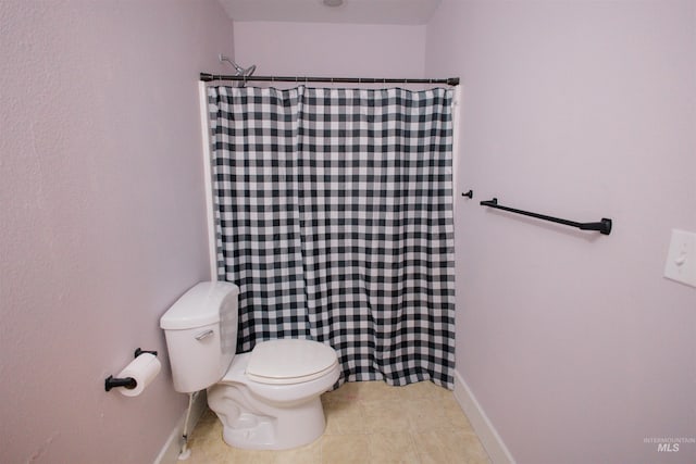 bathroom with toilet, a shower with shower curtain, and tile patterned flooring
