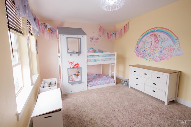 bedroom featuring light carpet and baseboards