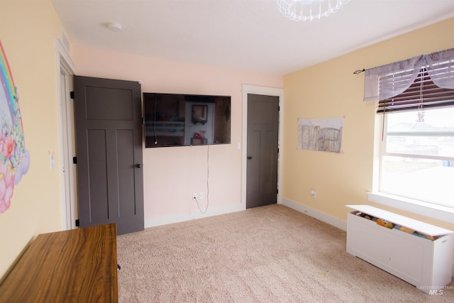 unfurnished bedroom with carpet floors and baseboards