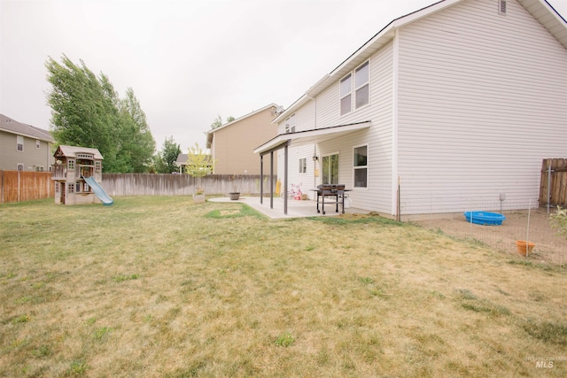 view of yard featuring a playground and a patio
