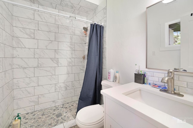 bathroom featuring vanity, toilet, walk in shower, and backsplash