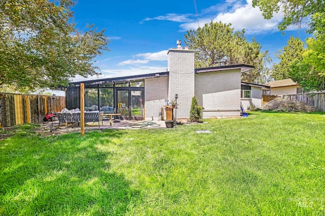 back of property featuring outdoor lounge area, a yard, and a patio