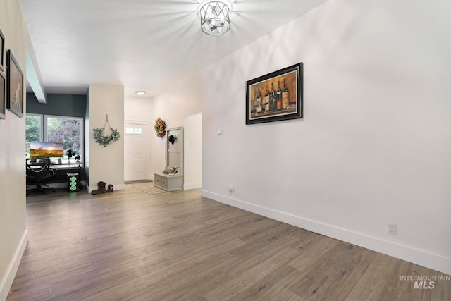 interior space with wood-type flooring and beam ceiling