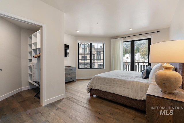 bedroom featuring hardwood / wood-style flooring and access to exterior